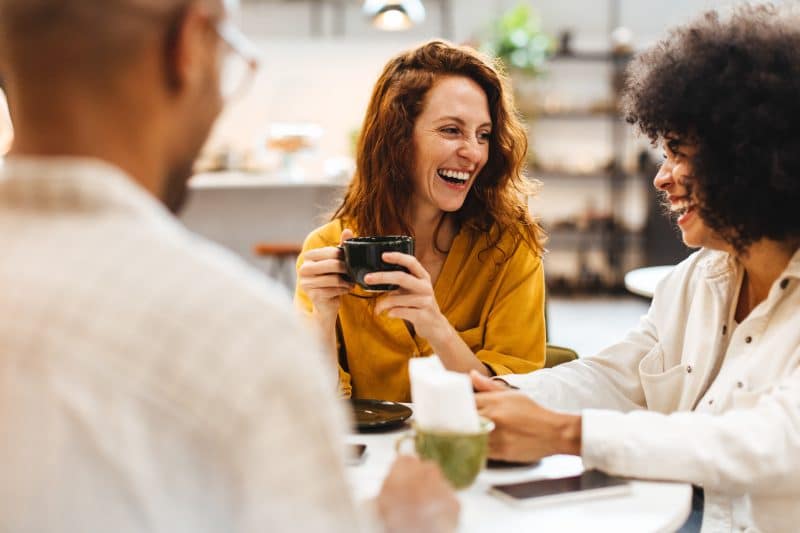 group of young people offering peer support for chronic illness over coffee